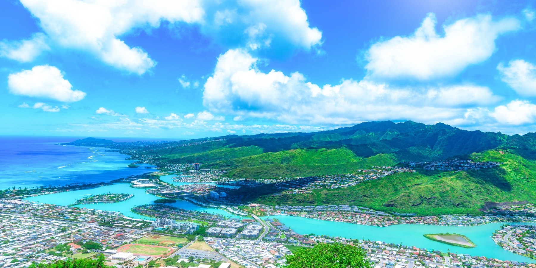 Aerial view of Hawaii Kai showing the Kuapa Pond marina channels, waterfront neighborhoods and the Koolau ridge