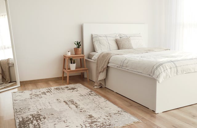 white bedroom with light brown furniture