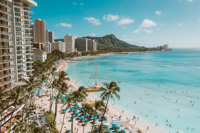 An aerial view of Waikiki Beach, its high-rise condominiums and Diamond Head.
