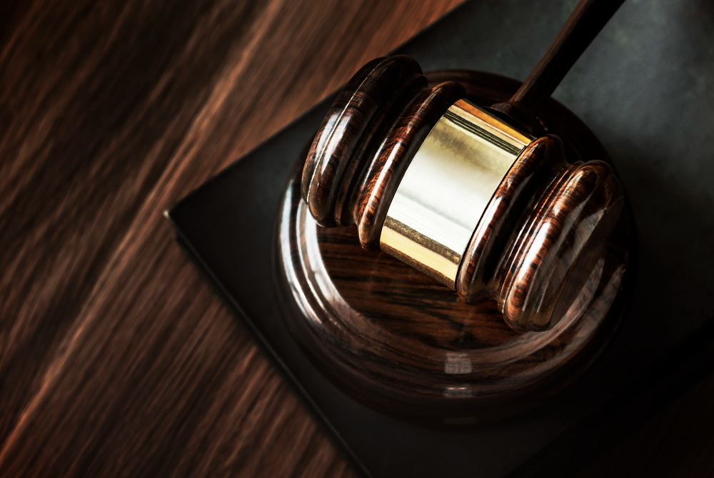 A close-up of a gavel resting on its block.