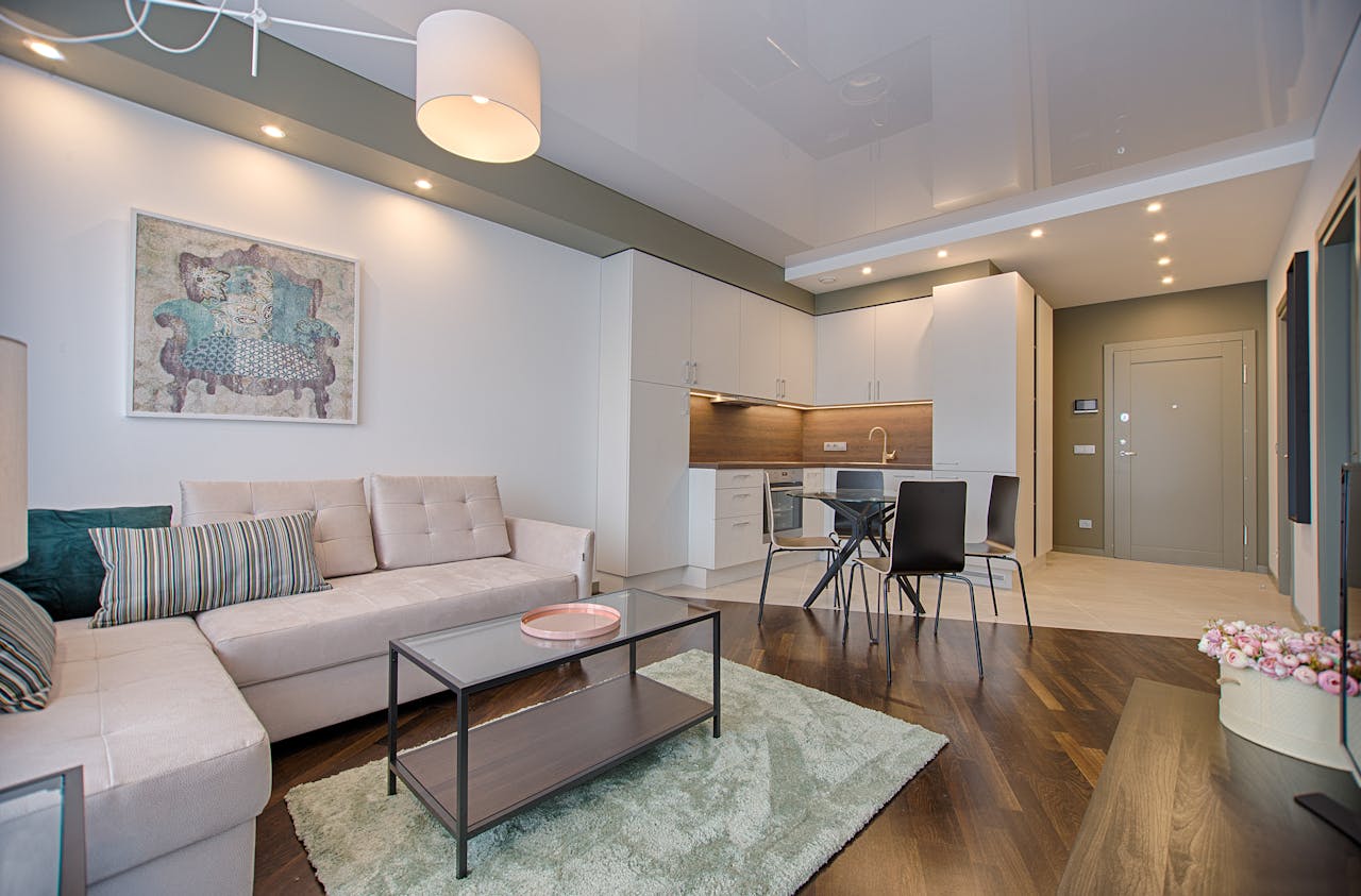 A rental interior with brown wood floors and white cabinetry.