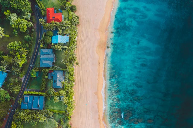 aerial-view-of-homes-along-the-beach-and-bright-blue-ocea
