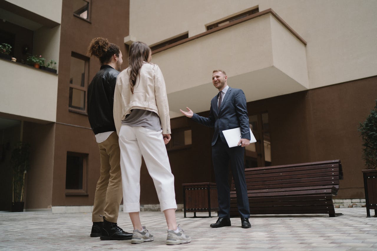 A property manager showing prospective tenants the amenities of a building.