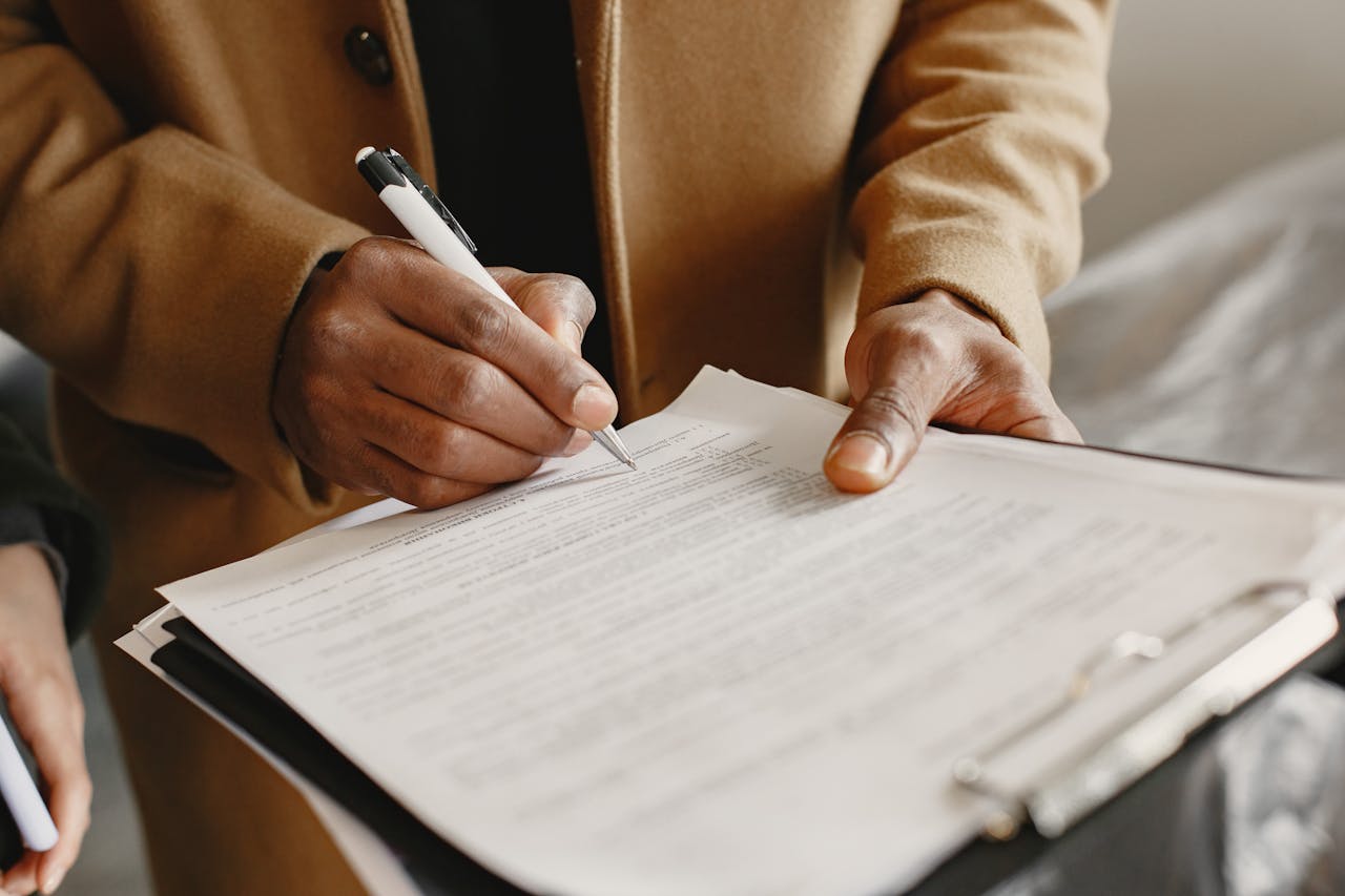 A landlord and tenant reviewing a lease agreement together at a table.