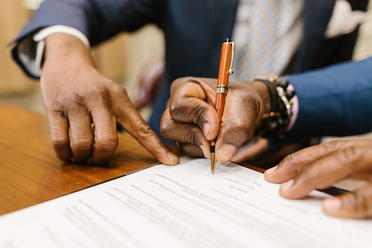 Two tenants signing a lease agreement.
