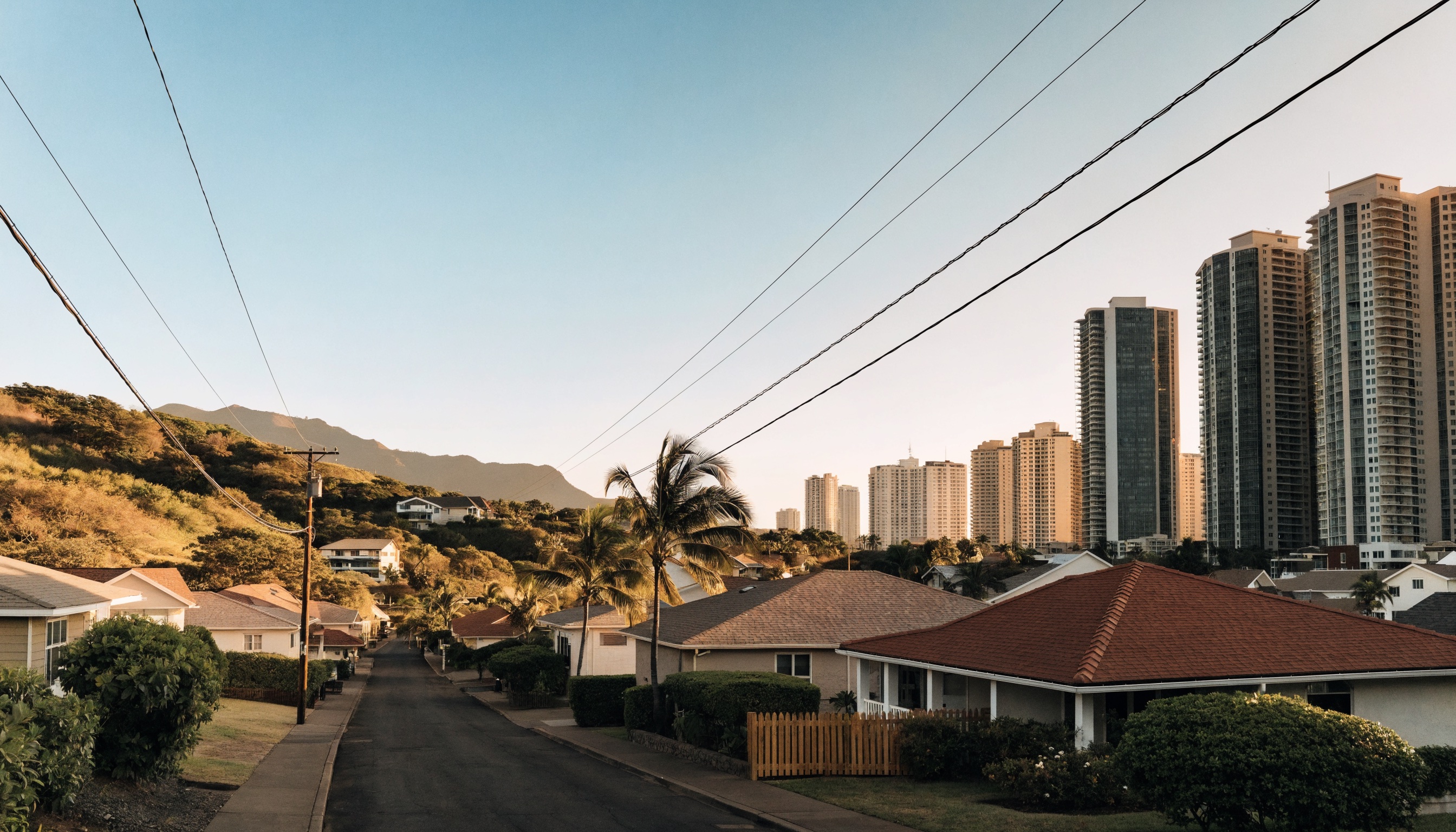 Waikiki high-rises and a Honolulu residential neighborhood representing different rental uses.