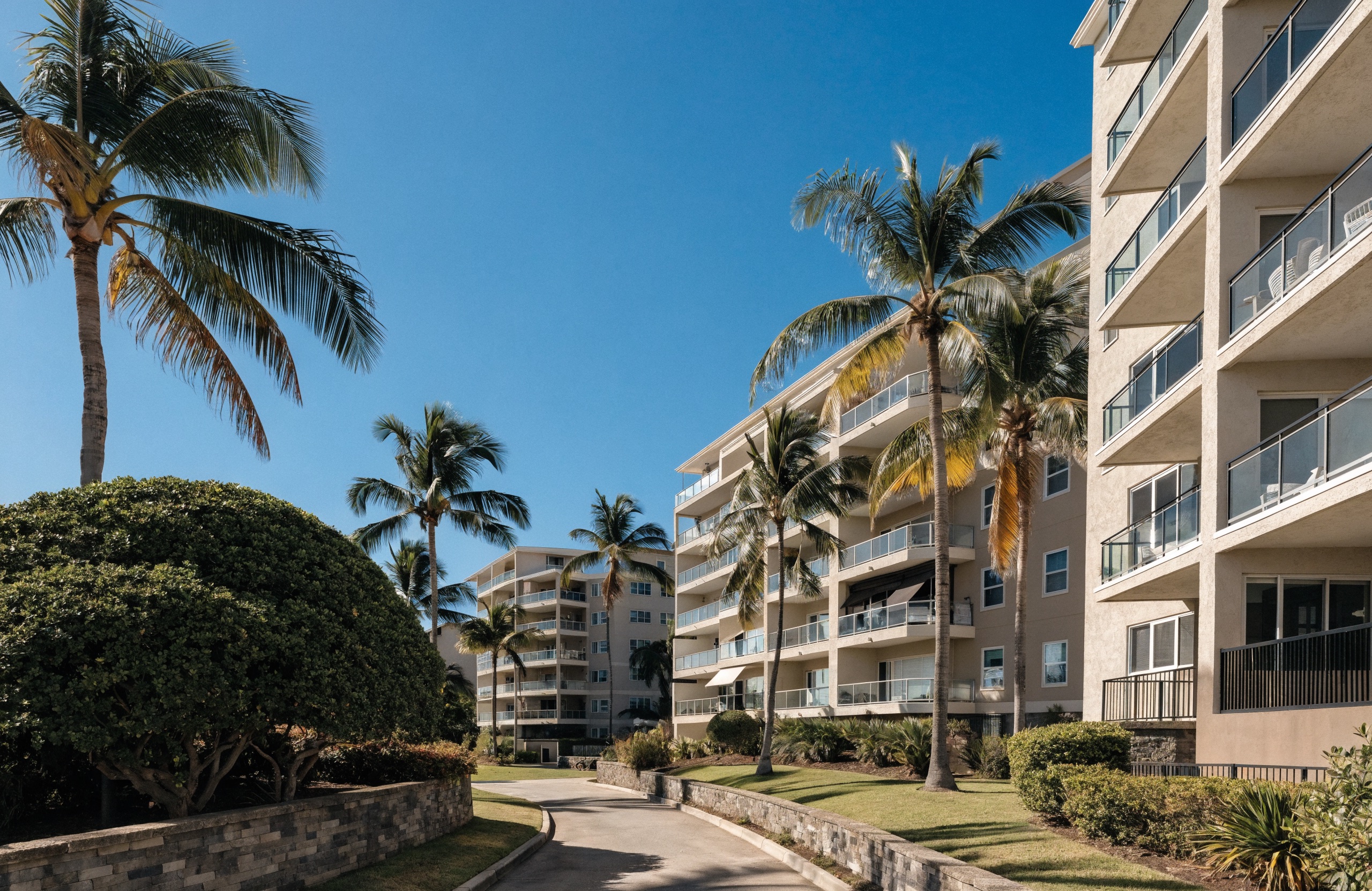 Mid-rise residential condominium buildings with lanais and palm trees in Honolulu.